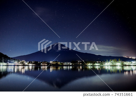 The silhouette of Mt. Fuji reflected in Lake Kawaguchi and the stars in the sky The silhouette of Mt. Fuji reflected in Lake Kawaguchi and the stars in the sky 74351661