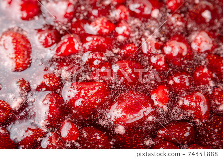 Cooking strawberry jam close up. 74351888