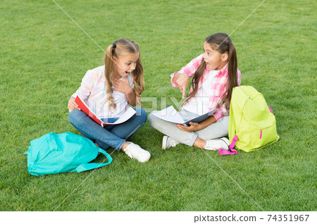 Little children girls read books sit on grass, knowledge day concept 74351967