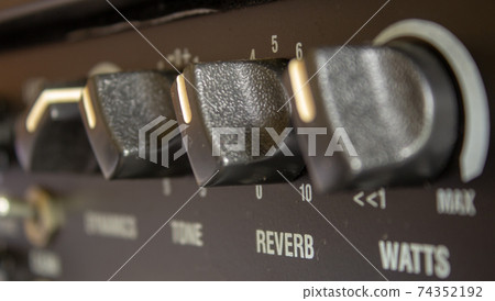 Buttons, knobs and lights of a guitar amplifier Buttons, knobs and lights of a guitar amplifier 74352192