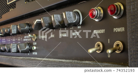 Buttons, knobs and lights of a guitar amplifier Buttons, knobs and lights of a guitar amplifier 74352193