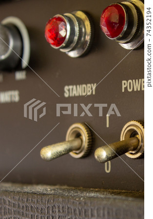 Buttons, knobs and lights of a guitar amplifier 74352194