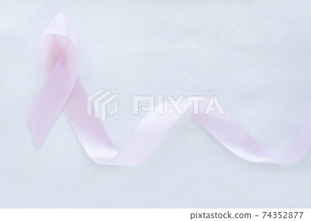 Lavender purple ribbon on white fabric with copy space. All cancer awareness, Testicular Cancer, Alzheimer disease, Epilepsy awareness, World Cancer Day. Healthcare or hospital and insurance concept. 74352877