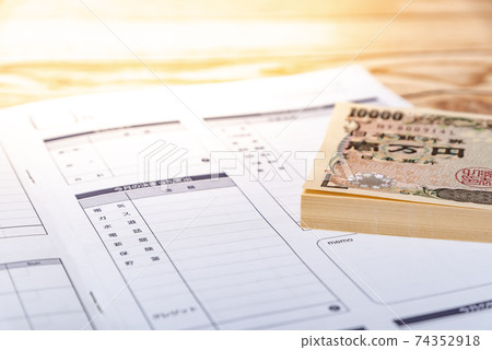 Wad of bills and household account book Wad of bills and household account book 74352918