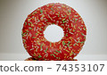 MACRO: Pink donut stands on a white dish 74353107