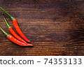 Chili Peppers on wood background 74353133