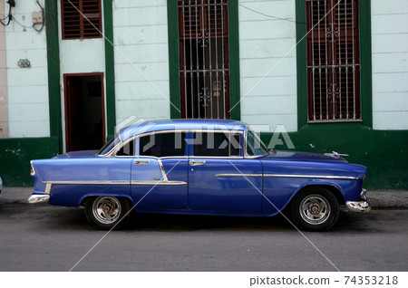 Backstreet in Havana, Cuba with old car 74353218