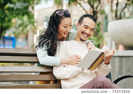 Couple reading together Couple reading together 74353848