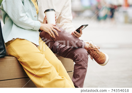 Couple sitting outdoors Couple sitting outdoors 74354018