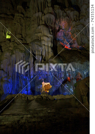 Stalactite and stalagmite formations in a limestone cave of Halong Bay, 74355134