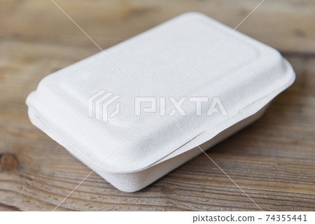 Service food order online delivery food box, delivery in take away boxes, disposable eco friendly packaging containers on wooden table at home. Service food order online delivery food box, delivery in take away boxes, disposable eco friendly packaging containers on wooden table at home. 74355441