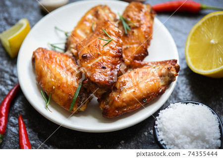 Baked chicken wings with sauce and herbs and spices cooking thai asian food rosemary chicken grilled. Baked chicken wings with sauce and herbs and spices cooking thai asian food rosemary chicken grilled. 74355444