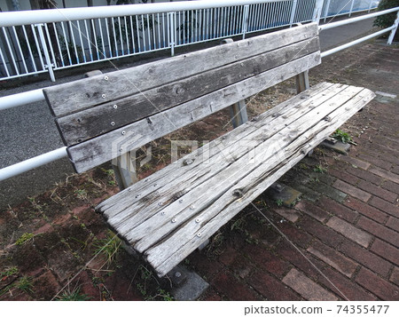 Old wooden bench on the roadside Old wooden bench on the roadside 74355477