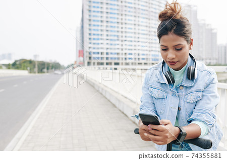 Woman answering text messages 74355881