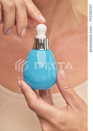 Close up of lady showing a jar of cosmetic product 74356207