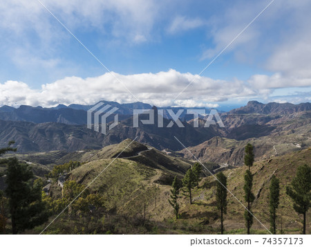 Amazing view on mountains, Caldera and Barranco de Tejeda and Roque Bentayg rock from Cruz de Tejeda Viewpoint. Gran Canaria, Canary Islands, Spain Amazing view on mountains, Caldera and Barranco de Tejeda and Roque Bentayg rock from Cruz de Tejeda Viewpoint. Gran Canaria, Canary Islands, Spain 74357173