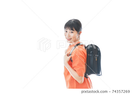 Young woman carrying a school bag Young woman carrying a school bag 74357269