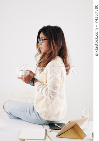 Woman having coffee break 74357380