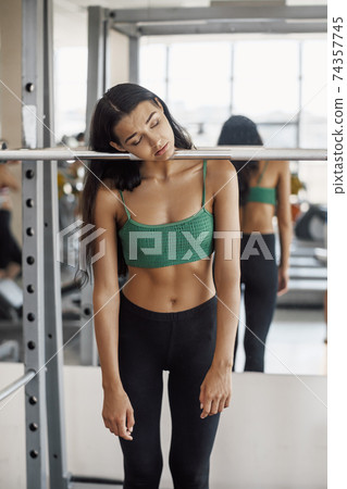 Tired Woman in a Gym After Workout Tired Woman in a Gym After Workout 74357745