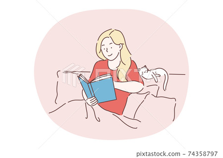 Reading, relaxing at home with book and cat, staying in bed concept 74358797