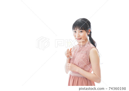 Young woman drinking wine at a party Young woman drinking wine at a party 74360198