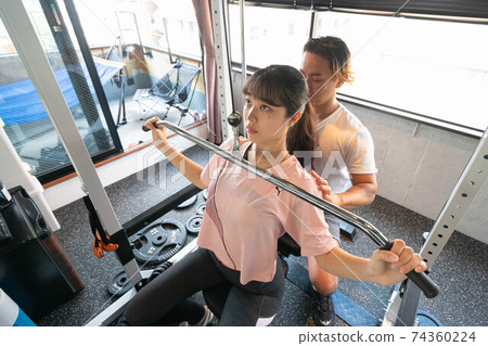 Women training in a personal training gym 74360224