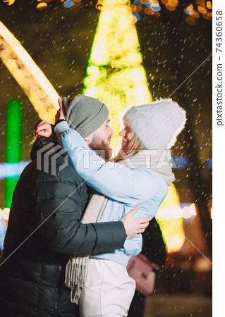 Young couple outdoor in night street at christmas time 74360658