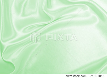 Smooth elegant green silk or satin luxury cloth texture as abstract background. Luxurious background design 74361048