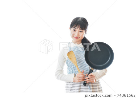 Newlywed woman cooking at home 74361562