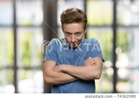 Angry teenager boy with crossed arms. Angry teenager boy with crossed arms. 74362090