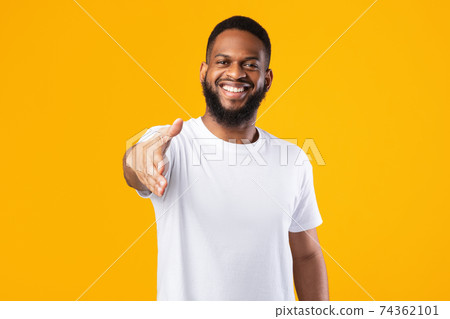 Happy African American Man Offering Hand For Handshake, Yellow Background Happy African American Man Offering Hand For Handshake, Yellow Background 74362101