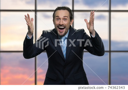 Portrait of mature excited businessman is celebrating. 74362343