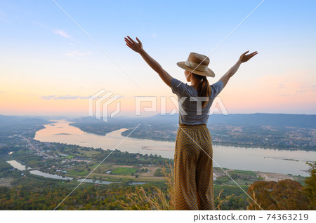 Asian woman enjoying high angle view of Mekong river Asian woman enjoying high angle view of Mekong river 74363219