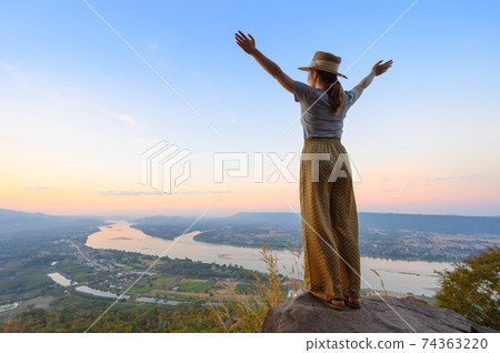Asian woman enjoying high angle view of Mekong river Asian woman enjoying high angle view of Mekong river 74363220