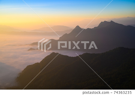 Beautiful misty mountain range in Laos from Phu Chi Fa mountain viewpoint in Chiang Rai 74363235