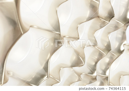Golden background made of plastic packaging for candy. Golden background made of plastic packaging for candy. 74364115