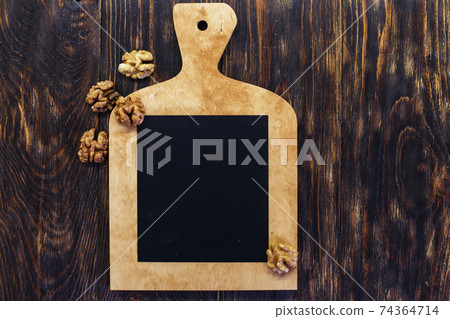 peeled walnuts in the white bowl close on brown old wooden table. healthy food concept peeled walnuts in the white bowl close on brown old wooden table. healthy food concept 74364714