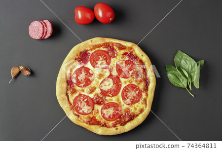 Pizza and ingredients on black 74364811