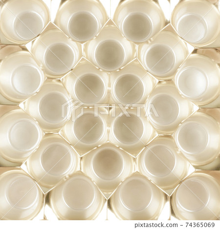 Golden background made of plastic packaging for candy. Golden background made of plastic packaging for candy. 74365069