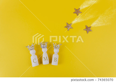 Three figures with crowns and three golden stars on yellow background. Three figures with crowns and three golden stars on yellow background. 74365070
