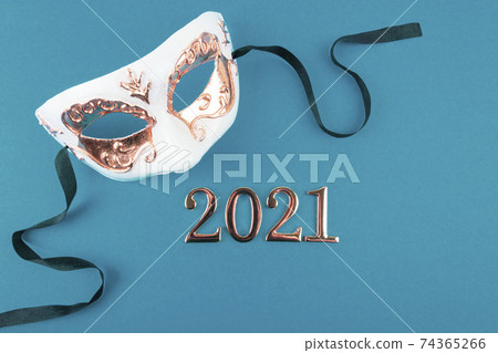 New Year carnival mask on blue background. New Year carnival mask on blue background. 74365266