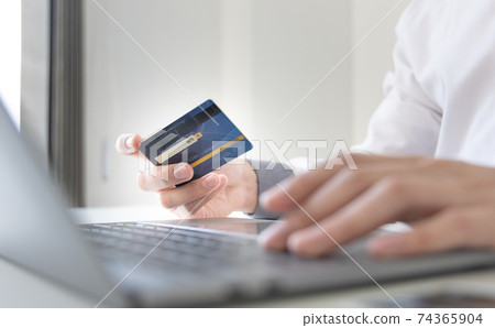 Online product purchase, Businessman use laptop register via credit cards to make online purchases, Shopping and mail, credit card online security, Online shopping concept. 74365904