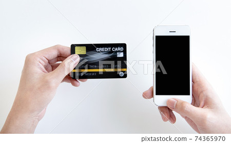 Businessman use mobile phones to register for security Online with a credit card to buy products online through application, Online shopping or Internet technology concept. Businessman use mobile phones to register for security Online with a credit card to buy products online through application, Online shopping or Internet technology concept. 74365970