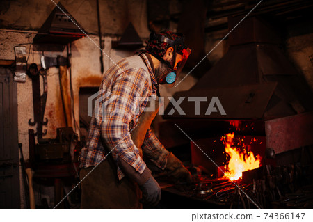Fire of blacksmith in the blacksmith's workshop. Fire of blacksmith in the blacksmith's workshop. 74366147