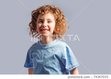 little girl jumps on a gray background little girl jumps on a gray background 74367035