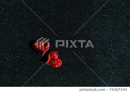 Little red hearts on the sparkle black background with copy space Little red hearts on the sparkle black background with copy space 74367249