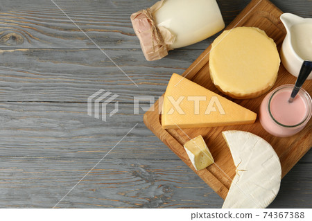 Different fresh dairy products on gray wooden background Different fresh dairy products on gray wooden background 74367388
