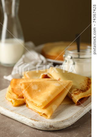 Concept of tasty breakfast with thin pancakes on gray table 74367428
