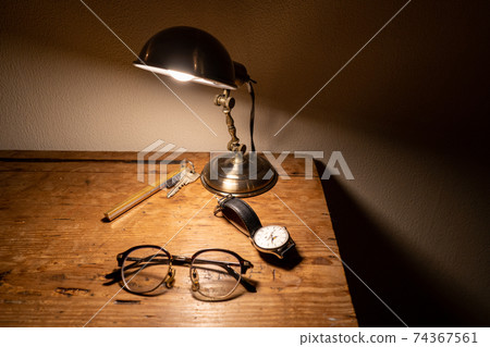 Glasses / keys / watches (horizontal) placed on an antique desk 74367561