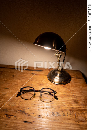 Glasses on an antique desk (vertical) 74367566